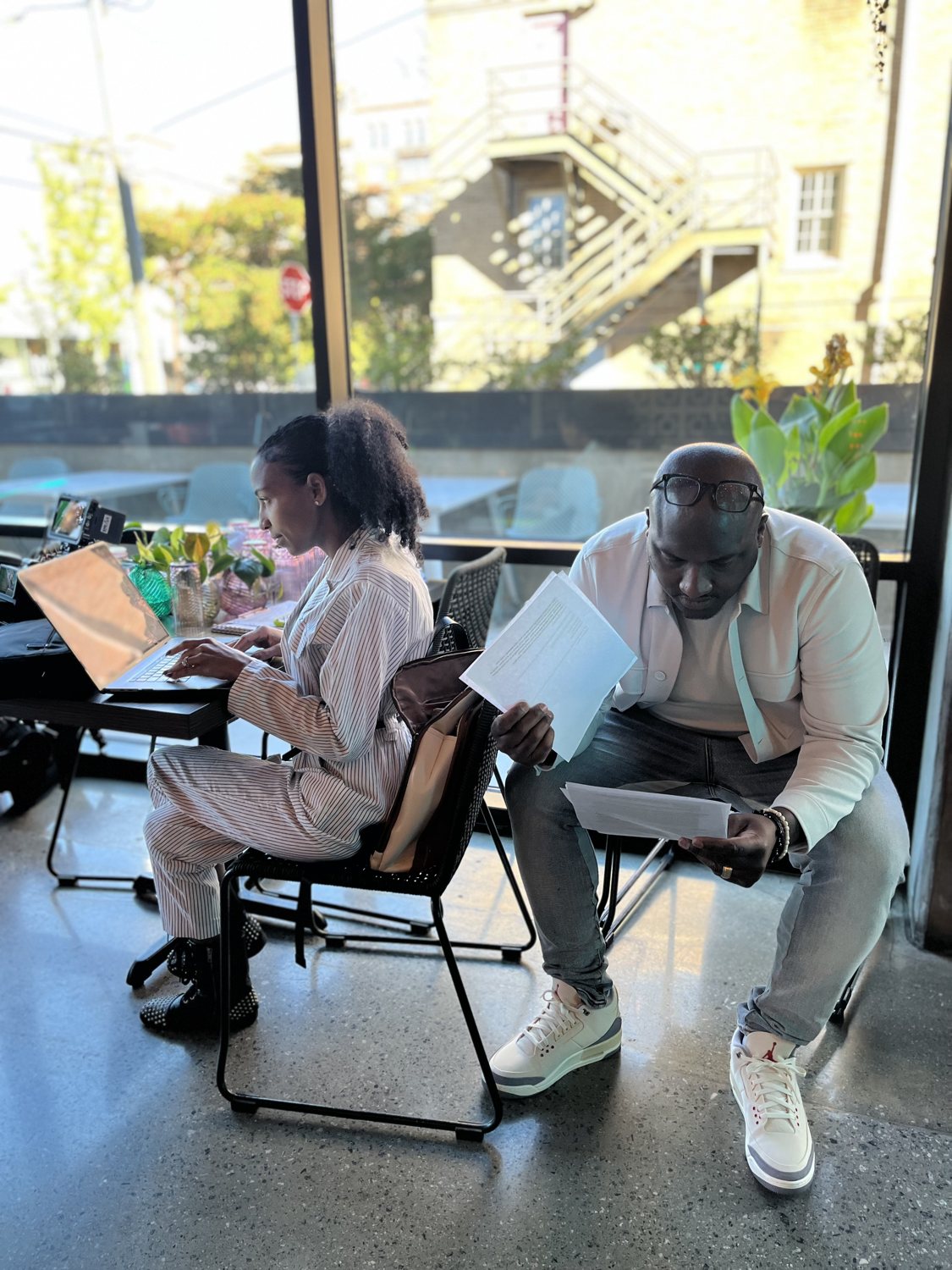Big Zak Wallace reviewing his script beside Chelsea on her laptop on the City Eats: Atlanta set
