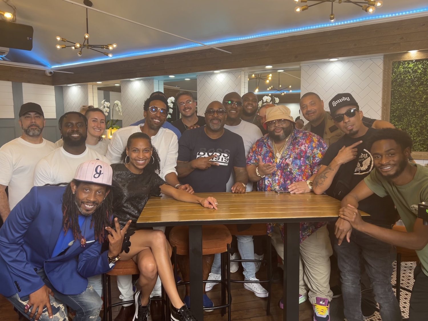 Chelsea with the cast and crew of City Eats: Atlanta around a restaurant table
